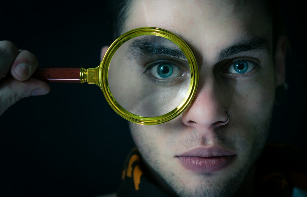investigator holding magnifying glass